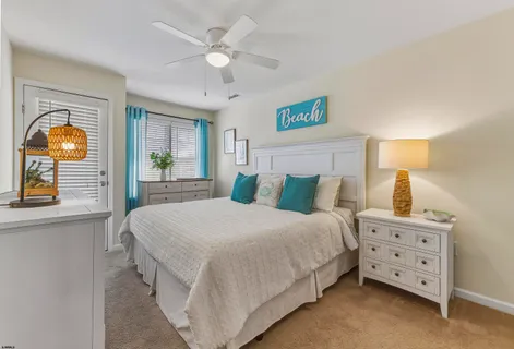 a bedroom with a bed a lamp and a dresser