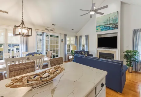 a large bedroom with a large bed and a flat tv screen on dresser