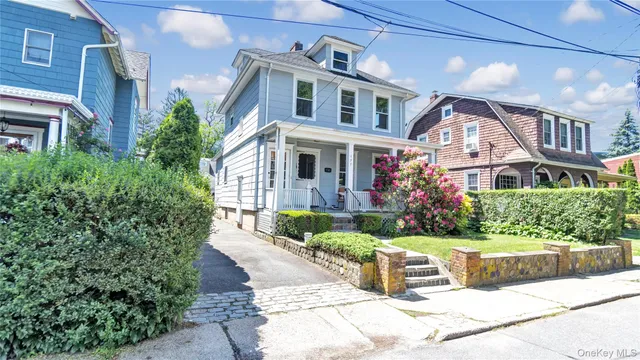 a front view of a house with a garden