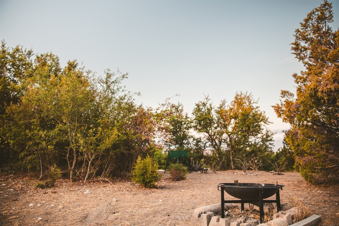 340 Ranch View Road Spicewood, TX 78669 - Photo 6 of 40 a view of a bench in the backyard of a house