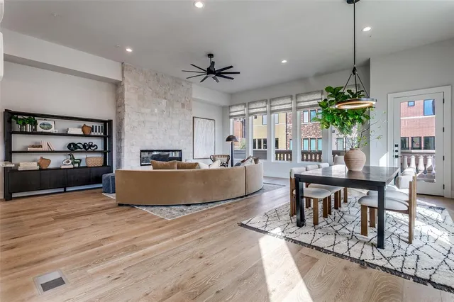 a living room with couches and a coffee table with wooden floors