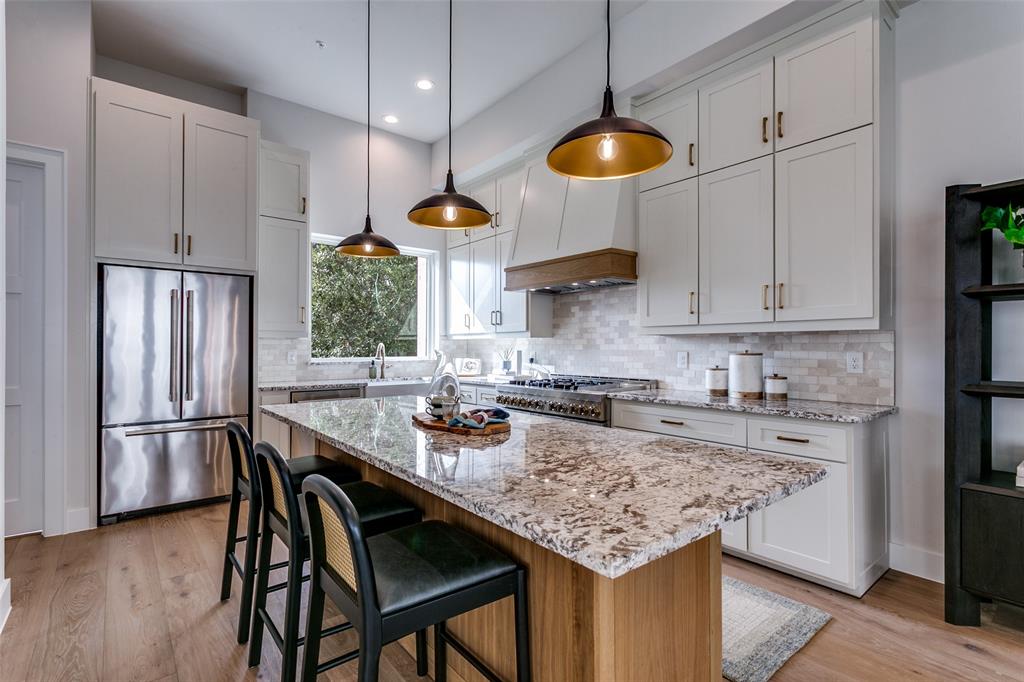 250 East Dallas Road, Unit 119 Grapevine, TX 76051 - Photo 18 of 40 a kitchen with stainless steel appliances granite countertop a sink a stove and a refrigerator