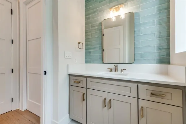 a bathroom with a double vanity sink and a mirror