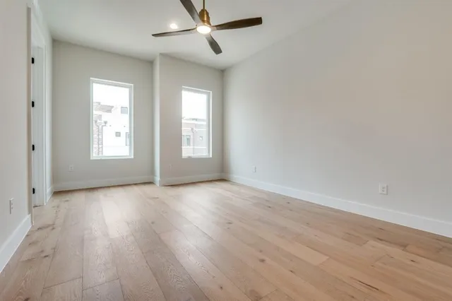 a bedroom with bed and wooden floor