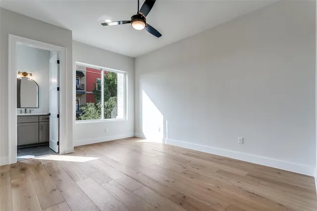 a bathroom with a toilet sink vanity tub and mirror