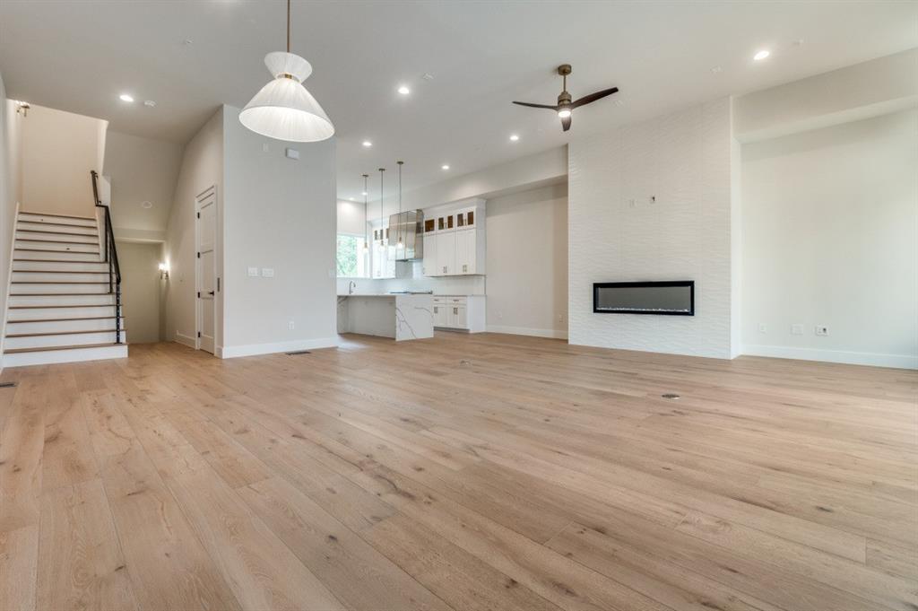 250 East Dallas Road, Unit 119 Grapevine, TX 76051 - Photo 7 of 40 an empty room with wooden floor and windows