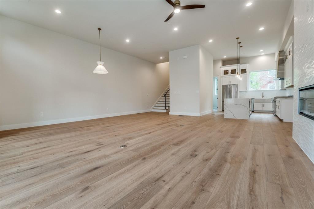 250 East Dallas Road, Unit 119 Grapevine, TX 76051 - Photo 8 of 40 an empty room with wooden floor and windows