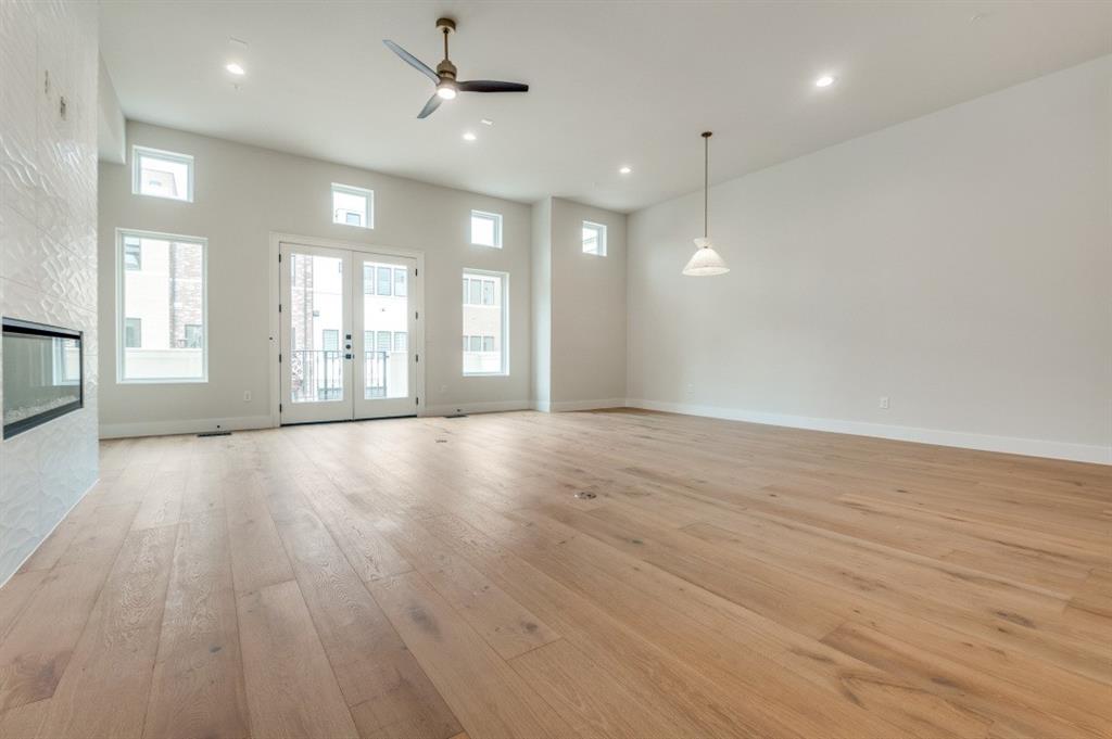 250 East Dallas Road, Unit 119 Grapevine, TX 76051 - Photo 9 of 40 an empty room with wooden floor and windows