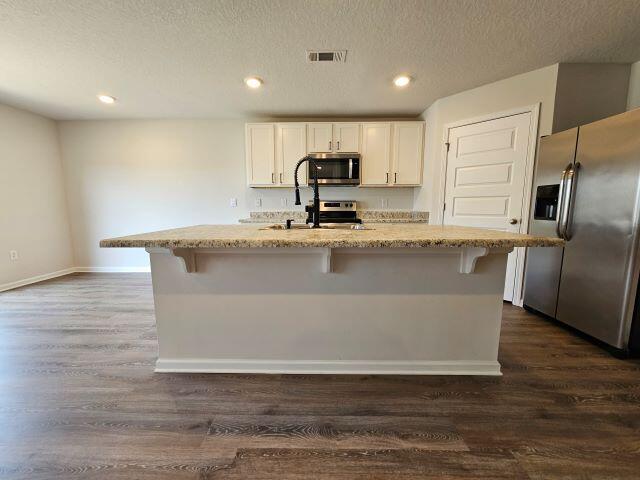 320 Flounder Street Crestview, FL 32539 - Photo 11 of 41 a large kitchen with granite countertop a large counter top and stainless steel appliances
