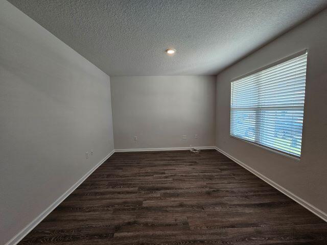 320 Flounder Street Crestview, FL 32539 - Photo 4 of 41 a view of an empty room with wooden floor and a window