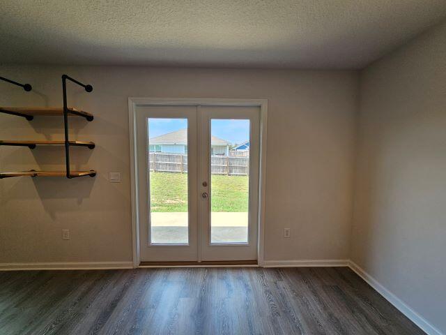 320 Flounder Street Crestview, FL 32539 - Photo 10 of 41 an empty room with wooden floor and windows