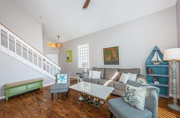 a living room with furniture and a wooden floor