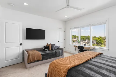 a bedroom with two beds and a large window