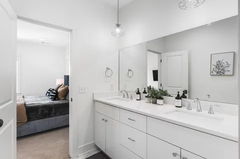 a en suite bathroom with double sink and a mirror