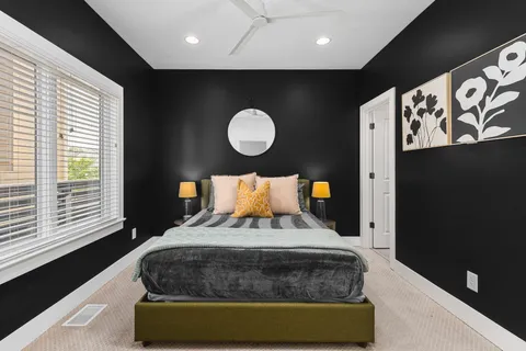 a bedroom with a bed and lamp