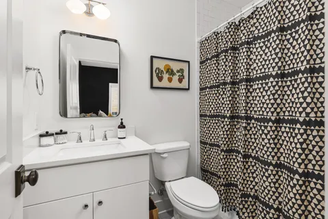 a kitchen with stainless steel appliances granite countertop a sink a stove and wooden floors