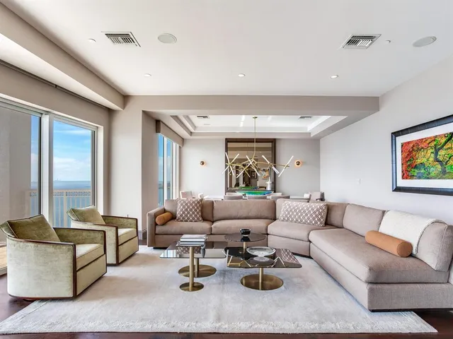 a living room with furniture and kitchen view