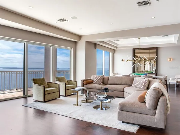 a dining room with furniture a rug and wooden floor