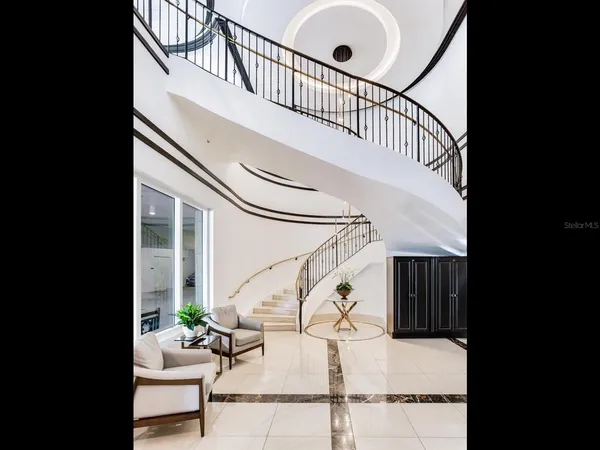 a view of a hallway with a dining table & chairs in a kitchen