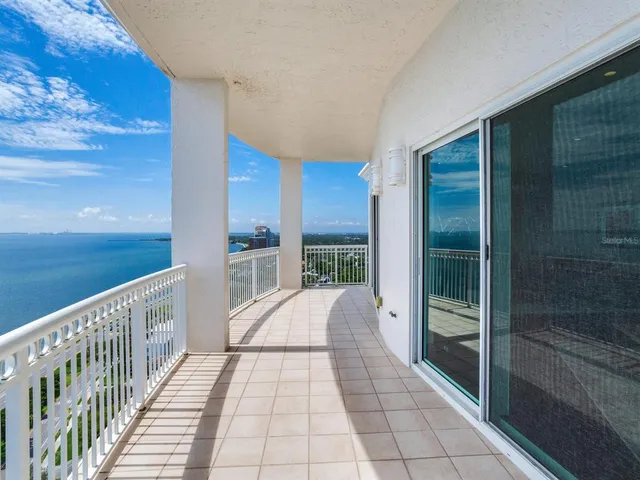 a view of a balcony with wooden fence