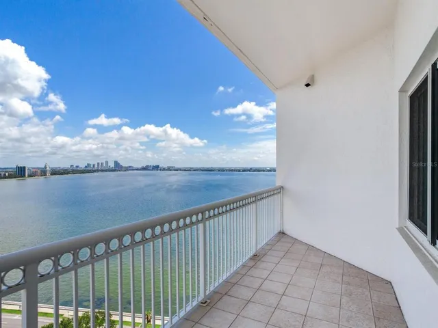 a dining hall with stainless steel appliances granite countertop a stove and a wooden floors