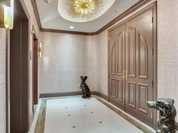 a living room with furniture and floor to ceiling windows