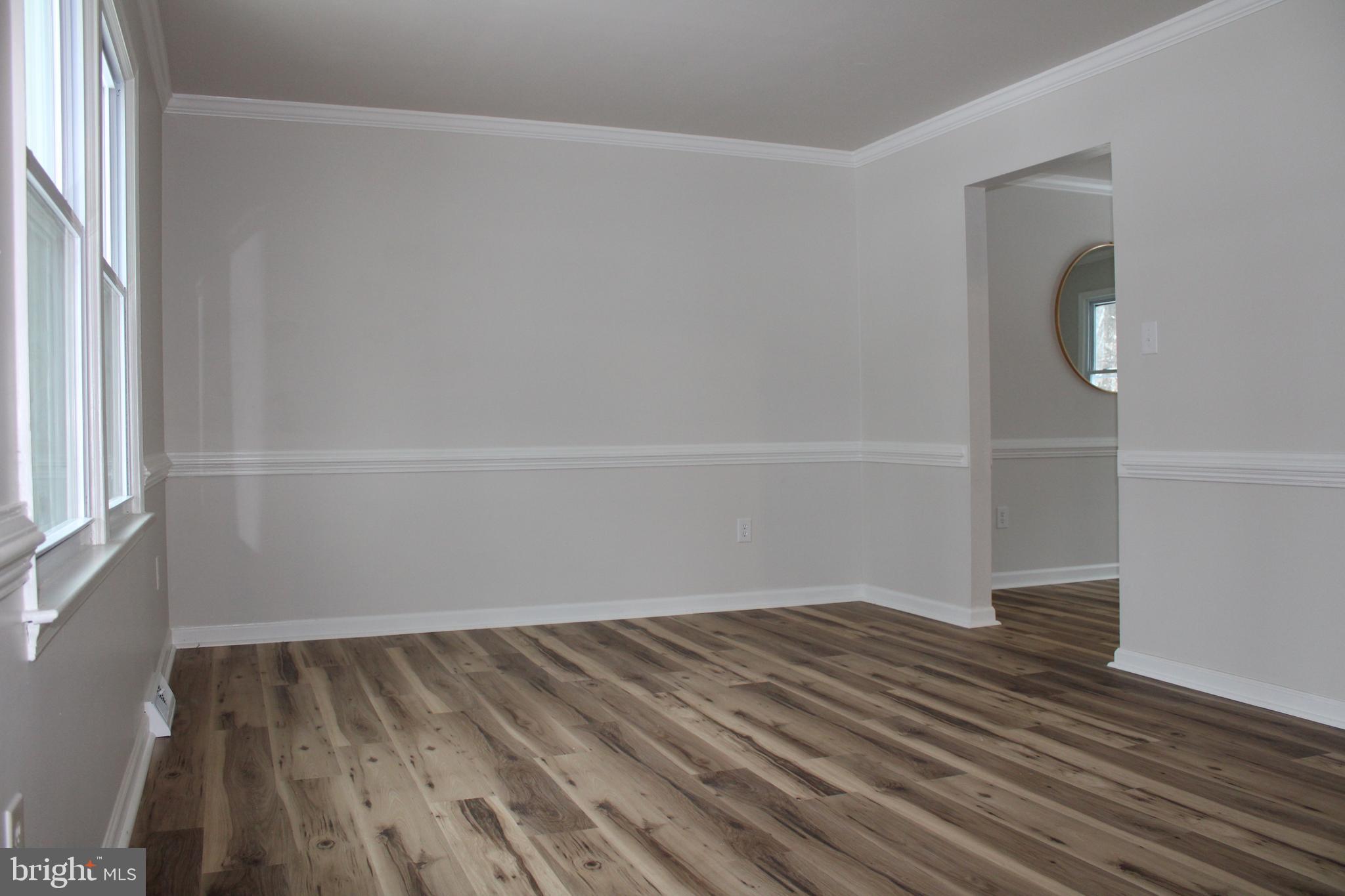 11816 Rutherford Drive Fredericksburg, VA 22407 - Photo 4 of 22 a view of a room with wooden floor and white walls