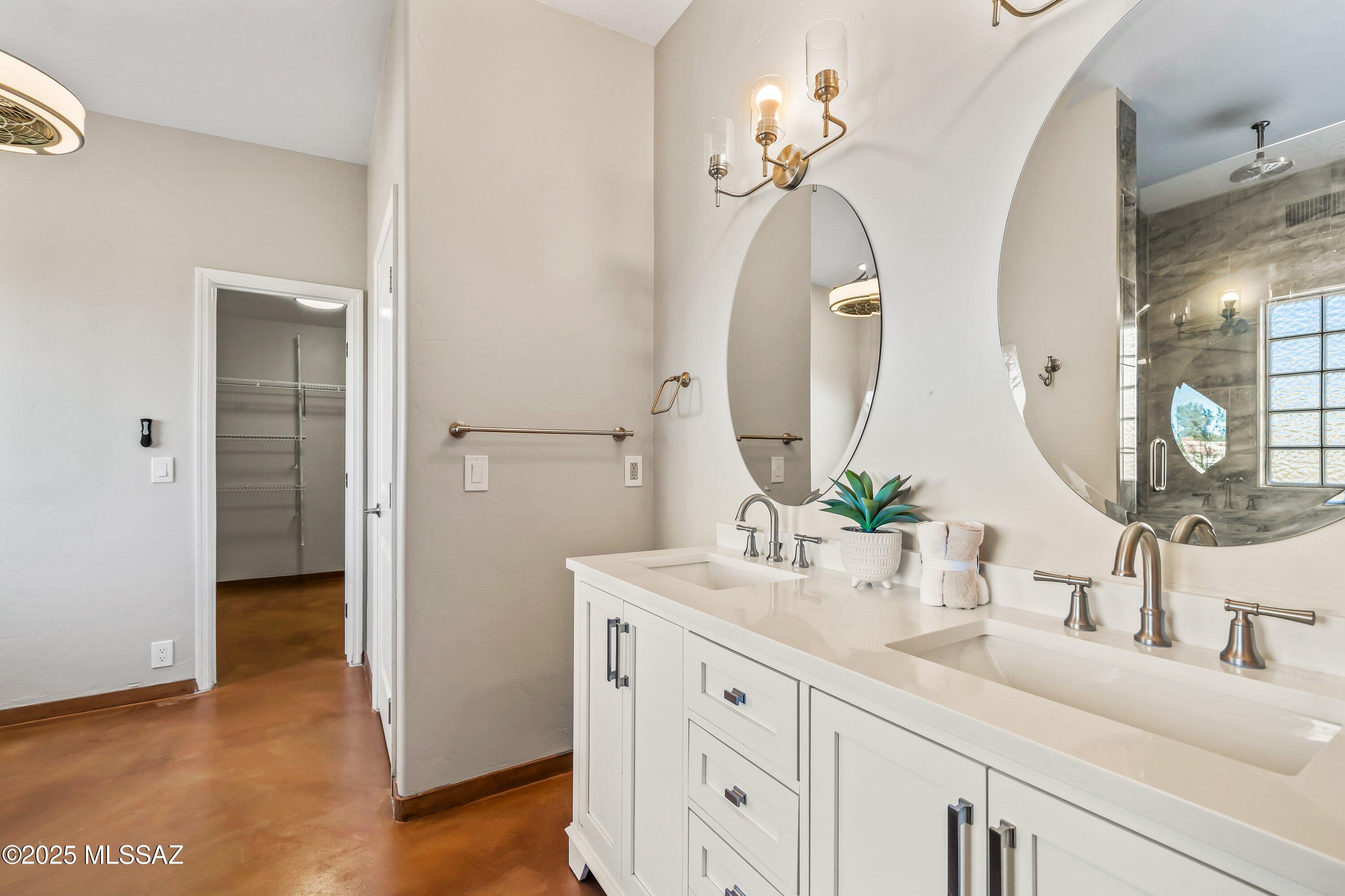 30 West Stone Loop Tucson, AZ 85704 - Photo 9 of 26 a bathroom with a double vanity sink and a mirror