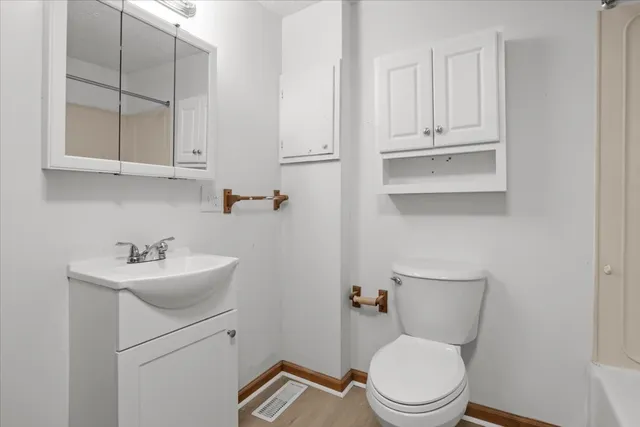 a bathroom with a sink a toilet and mirror
