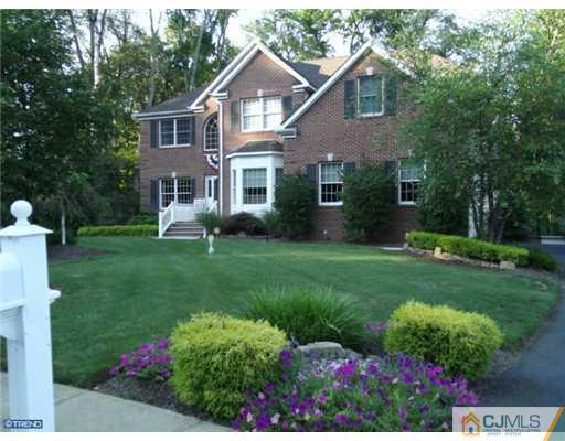 1 Cutter Court Cream Ridge, NJ 08514 - Photo 2 of 25 a front view of a house with a yard and trees