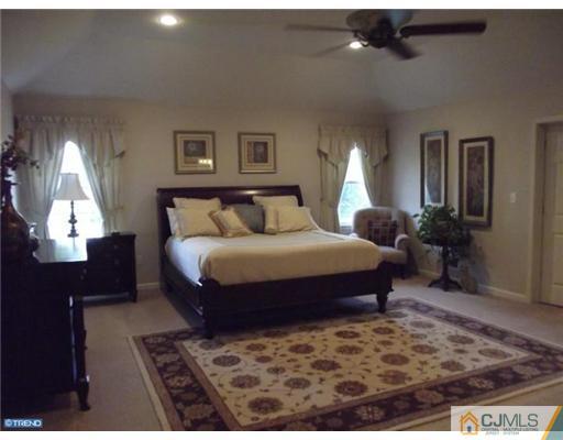 1 Cutter Court Cream Ridge, NJ 08514 - Photo 20 of 25 a bedroom with a bed and a lamp on desk