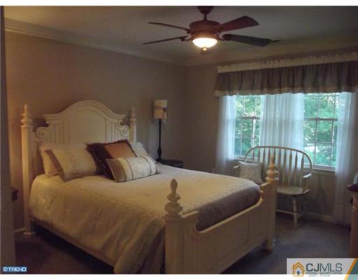 1 Cutter Court Cream Ridge, NJ 08514 - Photo 21 of 25 a bedroom with a bed and a chandelier