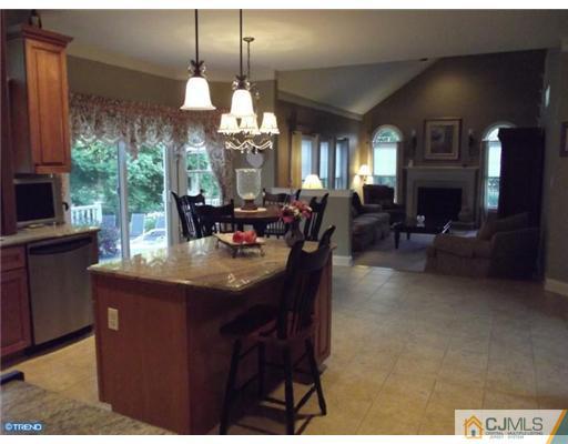 1 Cutter Court Cream Ridge, NJ 08514 - Photo 9 of 25 a dining room with furniture a chandelier a large window and a fireplace