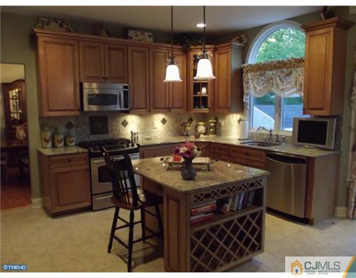 1 Cutter Court Cream Ridge, NJ 08514 - Photo 10 of 25 a kitchen with stainless steel appliances granite countertop a stove a sink dishwasher and microwave
