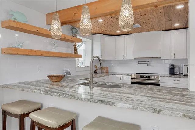 a kitchen with stainless steel appliances granite countertop a sink and cabinets