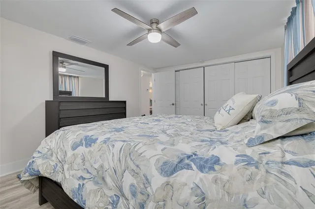 a bedroom with a bed and a painting on the wall