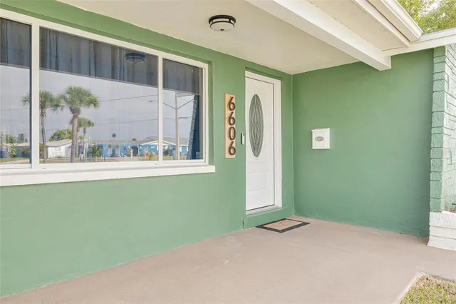 a view of a room that has a window and wooden floor