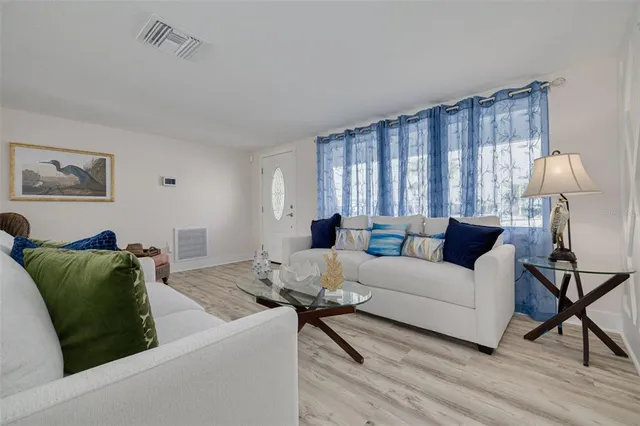 a living room with furniture and a lamp