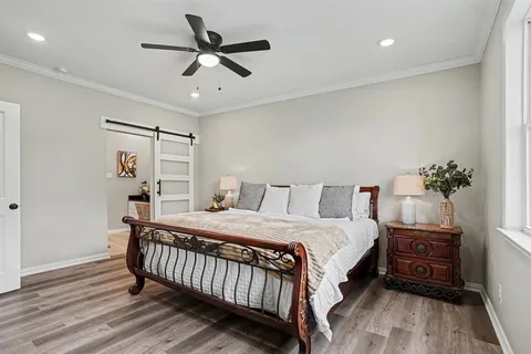 a bedroom with a large bed and a window