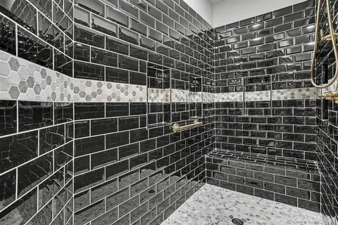 a en suite bathroom with a granite countertop sink and a mirror