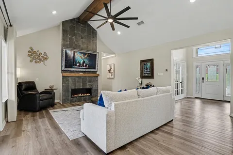a living room with furniture and a fireplace