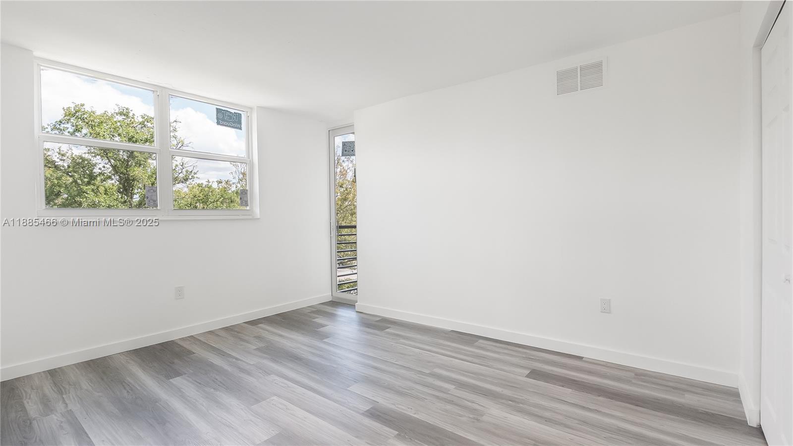 1820 Southwest 81st Avenue, Unit 3306 North Lauderdale, FL 33068 - Photo 13 of 15 an empty room with wooden floor and window