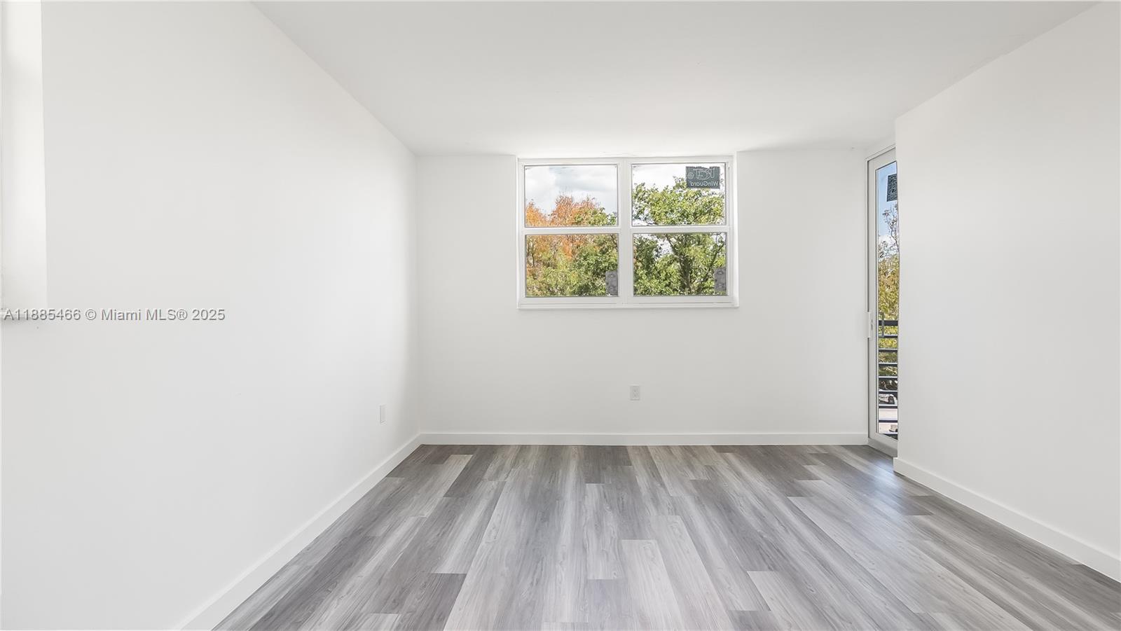 1820 Southwest 81st Avenue, Unit 3306 North Lauderdale, FL 33068 - Photo 15 of 15 an empty room with wooden floor and windows
