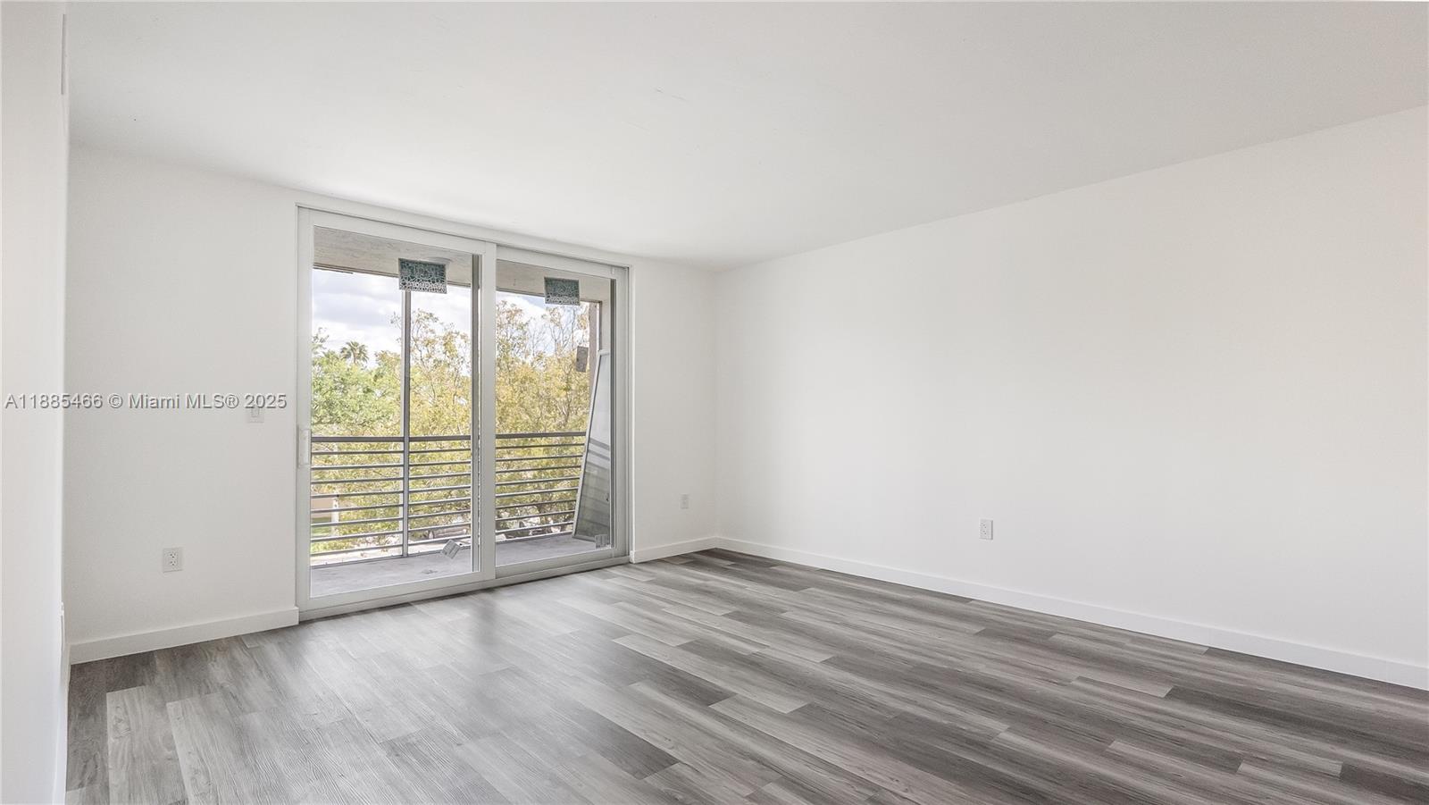 1820 Southwest 81st Avenue, Unit 3306 North Lauderdale, FL 33068 - Photo 4 of 15 an empty room with wooden floor and windows