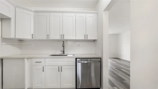 a kitchen with white cabinets and a sink