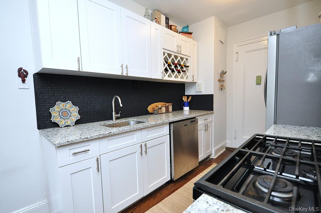 a kitchen with granite countertop a stove and a refrigerator