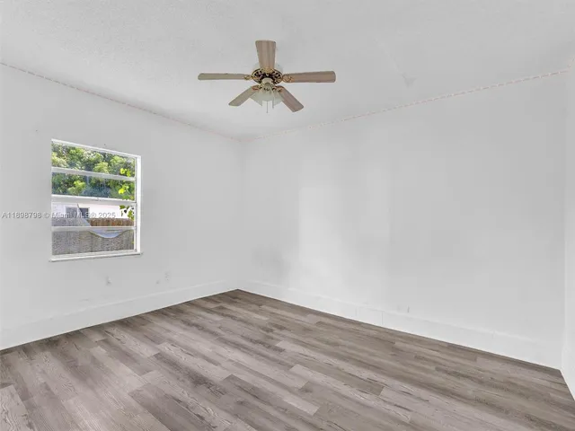a view of a room with wooden floor and natural light