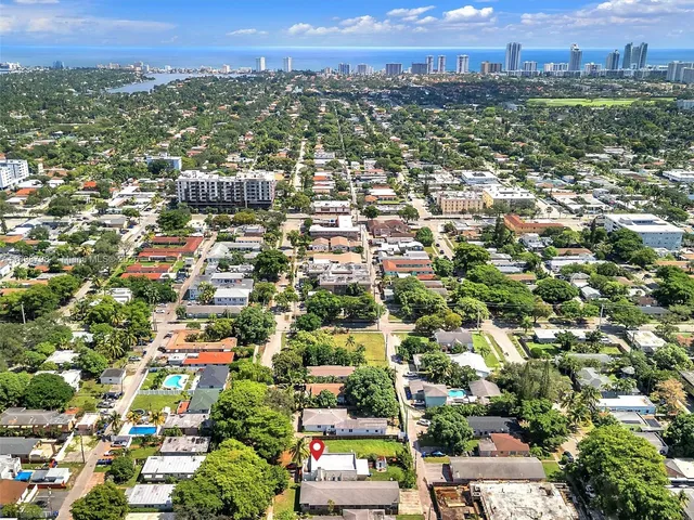 an aerial view of residential houses with city view