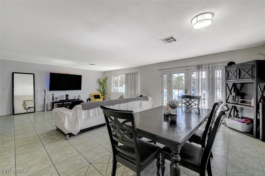 5248 Rambling Road Las Vegas, NV 89120 - Photo 15 of 35 Dining area featuring french doors and light tile patterned floors