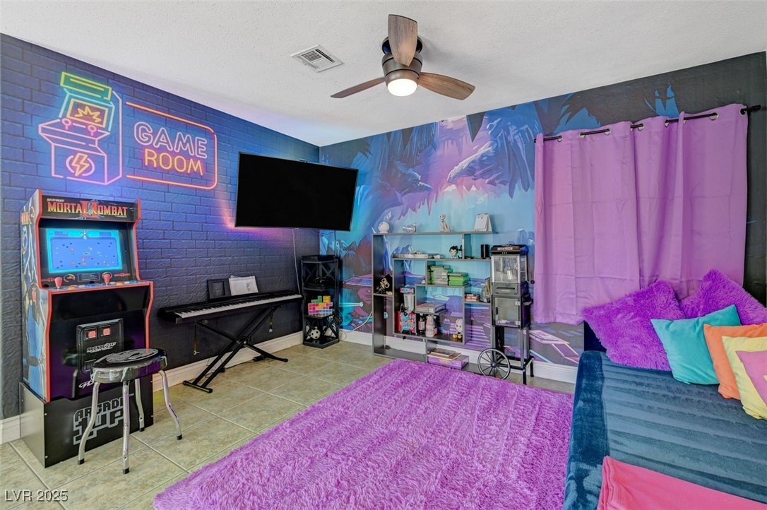 5248 Rambling Road Las Vegas, NV 89120 - Photo 20 of 35 Bedroom featuring tile patterned flooring, a ceiling fan, and a textured ceiling